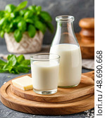 There is a glass of fresh milk on the table. Morning breakfast. Natural and environmentally friendly product. Still life. Стоковое AI-изображение, AI-художник Сергей Елизарьев / Фотобанк Лори