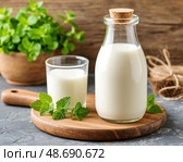 There is a glass of fresh milk on the table. Morning breakfast. Natural and environmentally friendly product. Still life. Стоковое AI-изображение, AI-художник Сергей Елизарьев / Фотобанк Лори