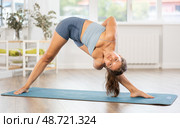 Young woman practicing hatha yoga in studio. Стоковое фото, фотограф Яков Филимонов / Фотобанк Лори