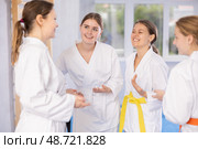 Group of young women are talking after successful and tedious karate workout. Стоковое фото, фотограф Яков Филимонов / Фотобанк Лори