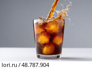 Pouring carbonated drink into glass with ice cubes and splashing on gray background. Стоковое AI-изображение, AI-художник Юрий Поздников / Фотобанк Лори