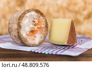 Head and chunks of aged hard cheese in hayloft. Стоковое фото, фотограф Татьяна Яцевич / Фотобанк Лори