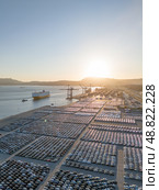 New Cars on Parking Lot and RORO cargo ship in Port of Setubal. Aerial View. Стоковое фото, фотограф Максим Забаровский / Фотобанк Лори