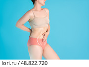 Abdomen liposuction, fat and cellulite removal concept, overweight female body with painted surgical lines and arrows. Стоковое фото, фотограф Станислав Тарко / Фотобанк Лори