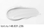 White skincare cream smear on white background, smooth cosmetic texture, beauty moisturizer sample, soft lotion spread, body care, facial hydration, wellness product, creamy consistency. Стоковое фото, фотограф Павел Муравьев / Фотобанк Лори