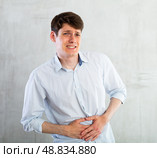 Man experiencing acute abdominal pain. Стоковое фото, фотограф Татьяна Яцевич / Фотобанк Лори