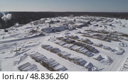 a view from a flying drone over a log warehouse at a woodworking factory in winter. Стоковое видео, видеограф Алексей Сергеев / Фотобанк Лори