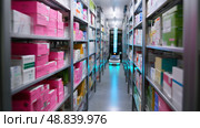 Robot retrieves items from shelves in a modern automated pharmacy during busy hours. Стоковое AI-изображение, AI-художник Сергей Толмачёв / Фотобанк Лори