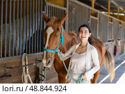 Young woman leads horse out of stable. Стоковое фото, фотограф Яков Филимонов / Фотобанк Лори