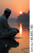 Mourner by a River at Twilight Whispers Prayers, Reflecting on Serenity and Nature. evoking Spiritual Retreats and Remembrance. Стоковое AI-изображение, AI-художник Sergey Grishin / Фотобанк Лори