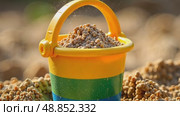 Colorful children toy bucket with sand stands in sandbox. AI Generative. Стоковое AI-видео, аниматор Spirit River / Фотобанк Лори