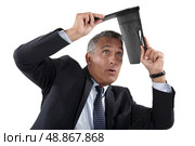 Businessman shielding himself. Стоковое фото, агентство Ingram Publishing / Фотобанк Лори