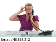 Woman reading a newspaper whilst on the phone. Стоковое фото, агентство Ingram Publishing / Фотобанк Лори