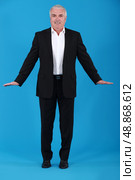 A mature businessman in a weird posture. Стоковое фото, агентство Ingram Publishing / Фотобанк Лори