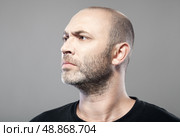 man look into the distance isolated on gray background . Стоковое фото, агентство Ingram Publishing / Фотобанк Лори