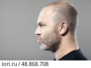 side portrait of gloomy man isolated on gray background with copyspace. Стоковое фото, агентство Ingram Publishing / Фотобанк Лори