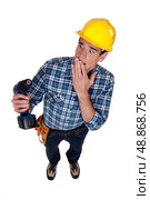 craftsman holding a drill and looking upset. Стоковое фото, агентство Ingram Publishing / Фотобанк Лори