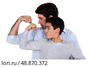 Father and son comparing their muscles. Стоковое фото, агентство Ingram Publishing / Фотобанк Лори