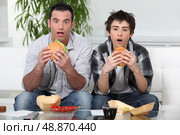 Brothers  eating hamburgers. Стоковое фото, агентство Ingram Publishing / Фотобанк Лори