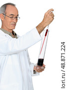 Grey haired man testing wine. Стоковое фото, агентство Ingram Publishing / Фотобанк Лори
