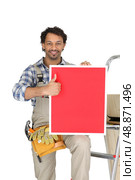 a handyman holding a panel. Стоковое фото, агентство Ingram Publishing / Фотобанк Лори