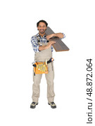 Labourer carrying plywood. Стоковое фото, агентство Ingram Publishing / Фотобанк Лори
