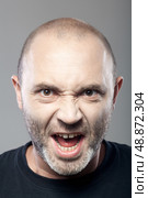 portrait of angry man screaming isolated on gray background. Стоковое фото, агентство Ingram Publishing / Фотобанк Лори