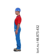 portrait of young craftsman standing in profile against studio background. Стоковое фото, агентство Ingram Publishing / Фотобанк Лори