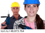 Man and woman holding power drills. Стоковое фото, агентство Ingram Publishing / Фотобанк Лори