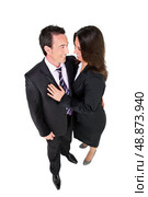 Couple in suits embracing against a white background. Стоковое фото, агентство Ingram Publishing / Фотобанк Лори