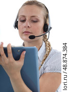 Call centre agent writing on a clipboard. Стоковое фото, агентство Ingram Publishing / Фотобанк Лори