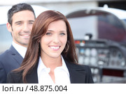 Couple standing by the cockpit of a light aircraft. Стоковое фото, агентство Ingram Publishing / Фотобанк Лори