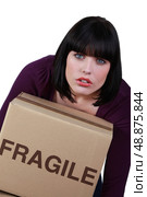 Woman carrying a heavy box marked fragile. Стоковое фото, агентство Ingram Publishing / Фотобанк Лори