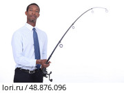 Man in a shirt and tie using a fishing rod. Стоковое фото, агентство Ingram Publishing / Фотобанк Лори