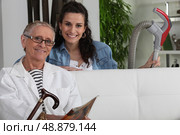 Young woman vacuuming for an elderly lady. Стоковое фото, агентство Ingram Publishing / Фотобанк Лори