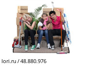 Roommates exhausted on moving day. Стоковое фото, агентство Ingram Publishing / Фотобанк Лори