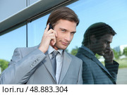 Slick executive using a cellphone. Стоковое фото, агентство Ingram Publishing / Фотобанк Лори