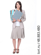 Twenty something dressed for the office with various folders. Стоковое фото, агентство Ingram Publishing / Фотобанк Лори
