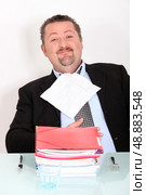 Man dining on a pile of files. Стоковое фото, агентство Ingram Publishing / Фотобанк Лори