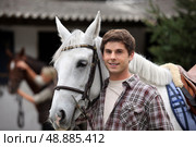 portrait of a young man with horse. Стоковое фото, агентство Ingram Publishing / Фотобанк Лори