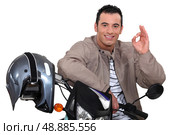 man on his motorbike making an okay sign. Стоковое фото, агентство Ingram Publishing / Фотобанк Лори