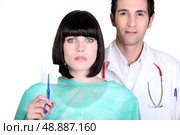 Hospital doctor and nurse holding a sterile gauze. Стоковое фото, агентство Ingram Publishing / Фотобанк Лори