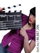 Young woman with cinema clap. Стоковое фото, агентство Ingram Publishing / Фотобанк Лори