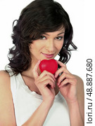 Flirtatious woman with heart in hand. Стоковое фото, агентство Ingram Publishing / Фотобанк Лори