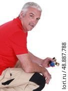 Man with a piece of plumbing. Стоковое фото, агентство Ingram Publishing / Фотобанк Лори
