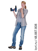 Woman with power drill making shush gesture. Стоковое фото, агентство Ingram Publishing / Фотобанк Лори