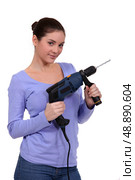 girl posing with drill. Стоковое фото, агентство Ingram Publishing / Фотобанк Лори