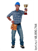 Happy builder holding trophy. Стоковое фото, агентство Ingram Publishing / Фотобанк Лори
