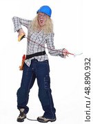 Female electrician getting a shock. Стоковое фото, агентство Ingram Publishing / Фотобанк Лори