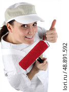 Cheerful decorator with a paint roller. Стоковое фото, агентство Ingram Publishing / Фотобанк Лори